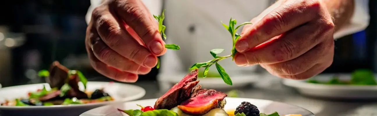 Chef dressant une assiette dans la cuisine d’un restaurant